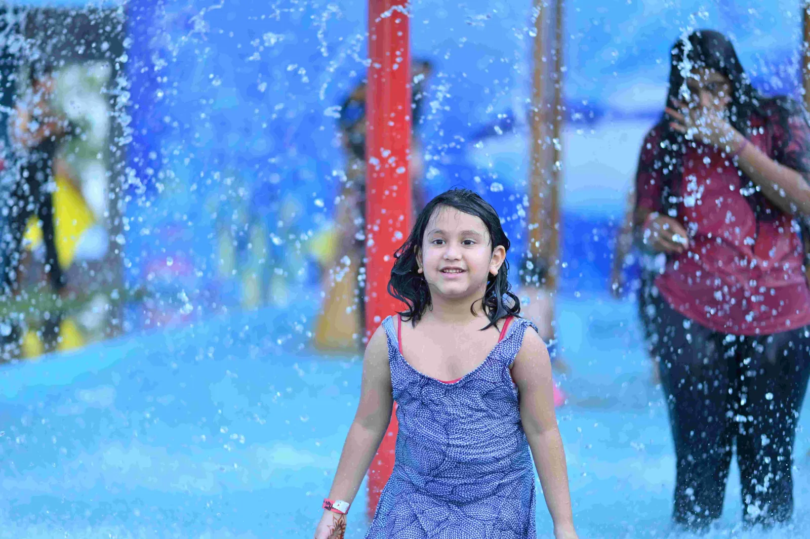 Girl laughing under the rain dance showers at Shagun Resorts