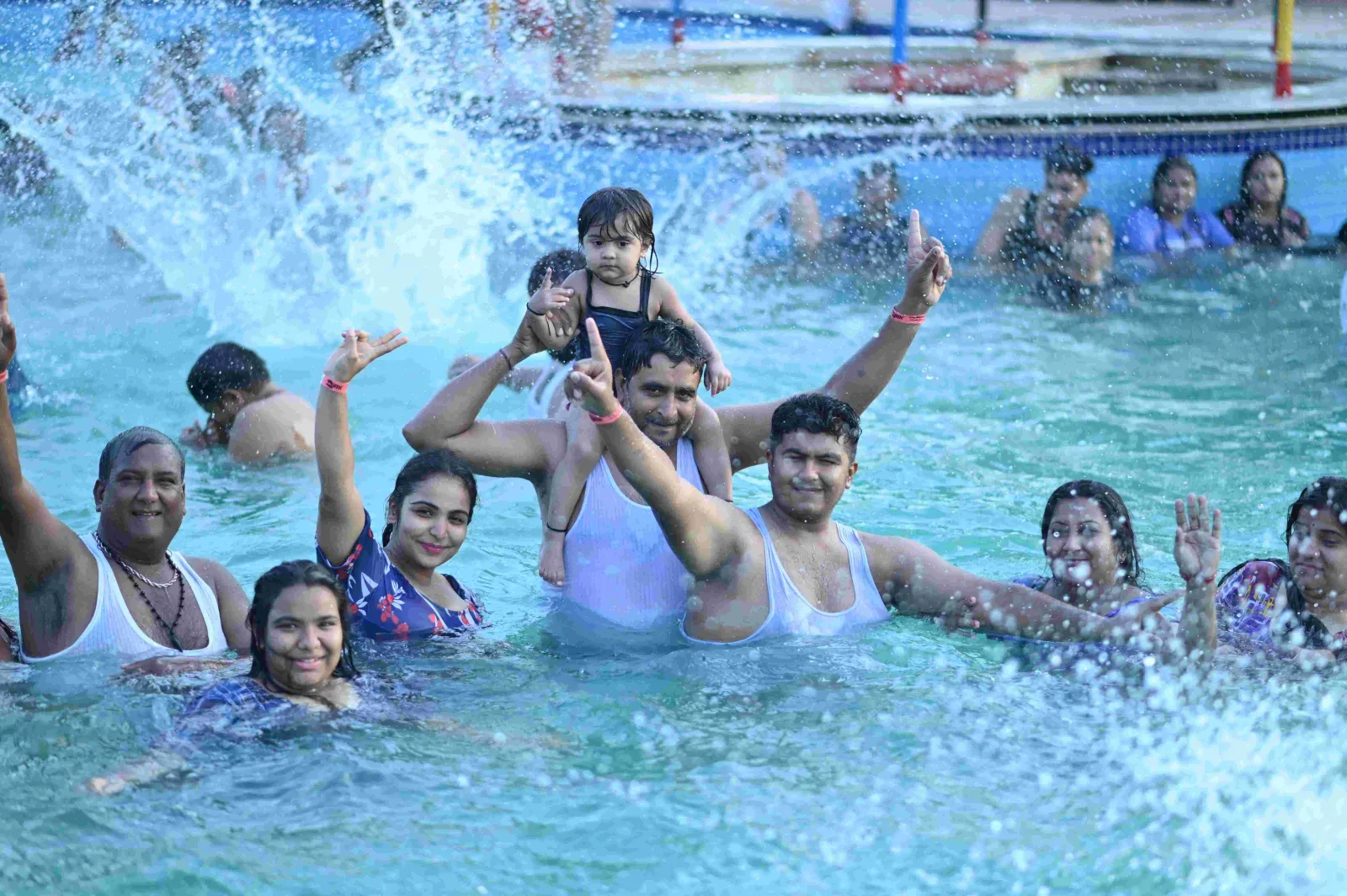 Friends splashing in the wave pool at a pool party at Shagun Resorts, Jodhpur